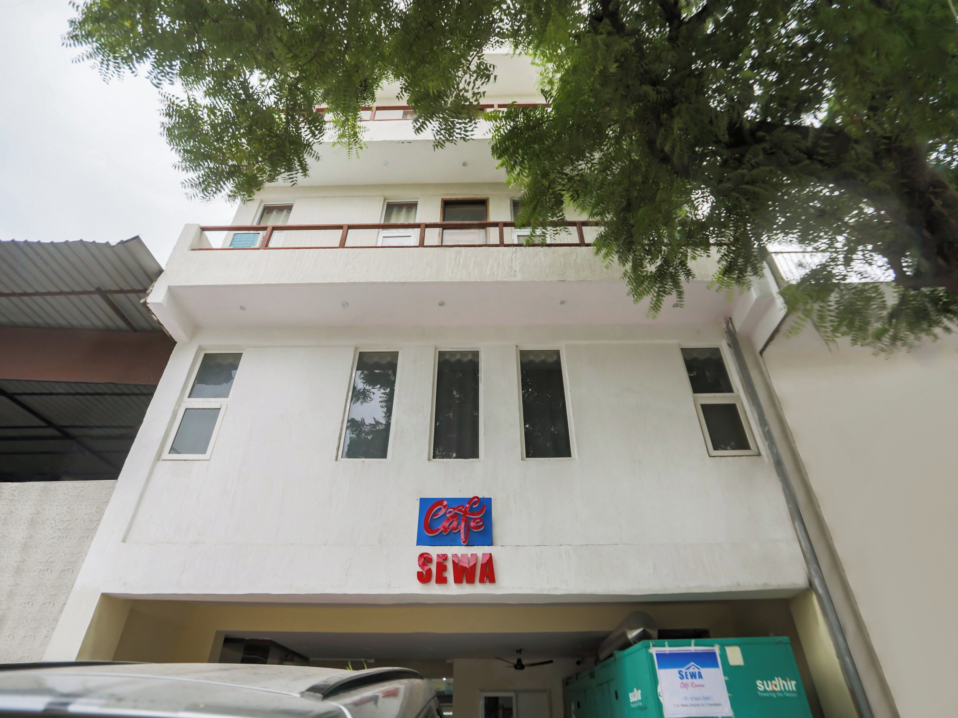 A building with a cafe sign and a sign for Sewam.