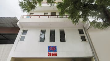 A building with a cafe sign and a sign for Sewam.