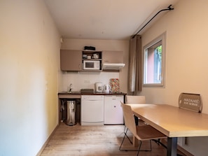 A compact kitchen with a microwave, coffee maker, and a small refrigerator. - Apartment with a terrace and an outdoor pool (Ax-les-Thermes)