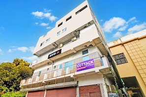 A multi-story building with a sign for 'New Cuttack Guest House' indicating lodging and boarding services. - Hotel O New Cuttack Guest House (Cuttack)