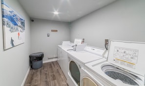 A laundry room with a washing machine, dryer, and a trash bin. - Ski In/Ski Out Access to Giant Steps (Brian Head)
