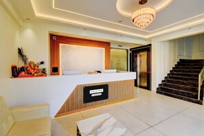 A hotel reception area with a reception desk, a reception sign, a reception area sign, a reception desk with a company-serviced sign, a reception desk with a reception sign, a reception desk with a reception area sign, a reception desk with a company-serviced sign, a reception desk with a reception area sign, a reception desk with a company-serviced sign, a reception desk with a reception area sign, a reception desk with a company-serviced sign, a reception desk with a reception area sign, a reception desk with a company-serviced sign, a reception desk with a reception area sign, a reception desk with a company-serviced sign, a reception desk with a reception area sign, a reception desk with a company-serviced sign, a reception desk with a reception area sign, a reception desk with a company-serviced sign, a reception desk with a reception area sign, a reception desk with a company-serviced sign, a reception desk with a reception area sign, - Palette Hotel Chakan K9 (Rajgurunagar)