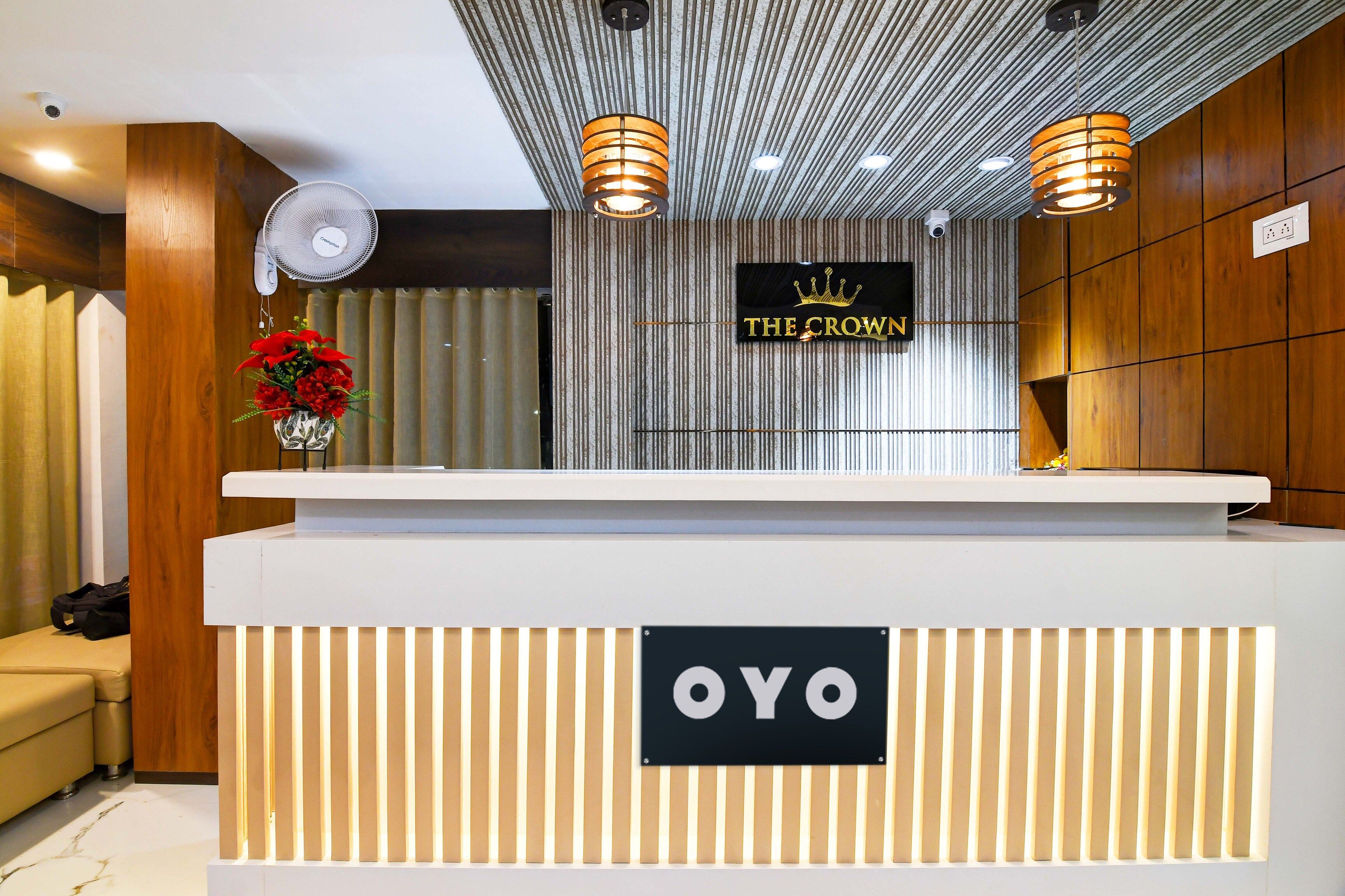 A reception desk with a sign reading 'THE CROWN' and 'OYO' below it.