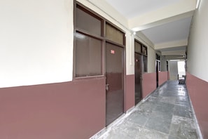 A corridor with doors marked with numbers, leading to individual rooms.