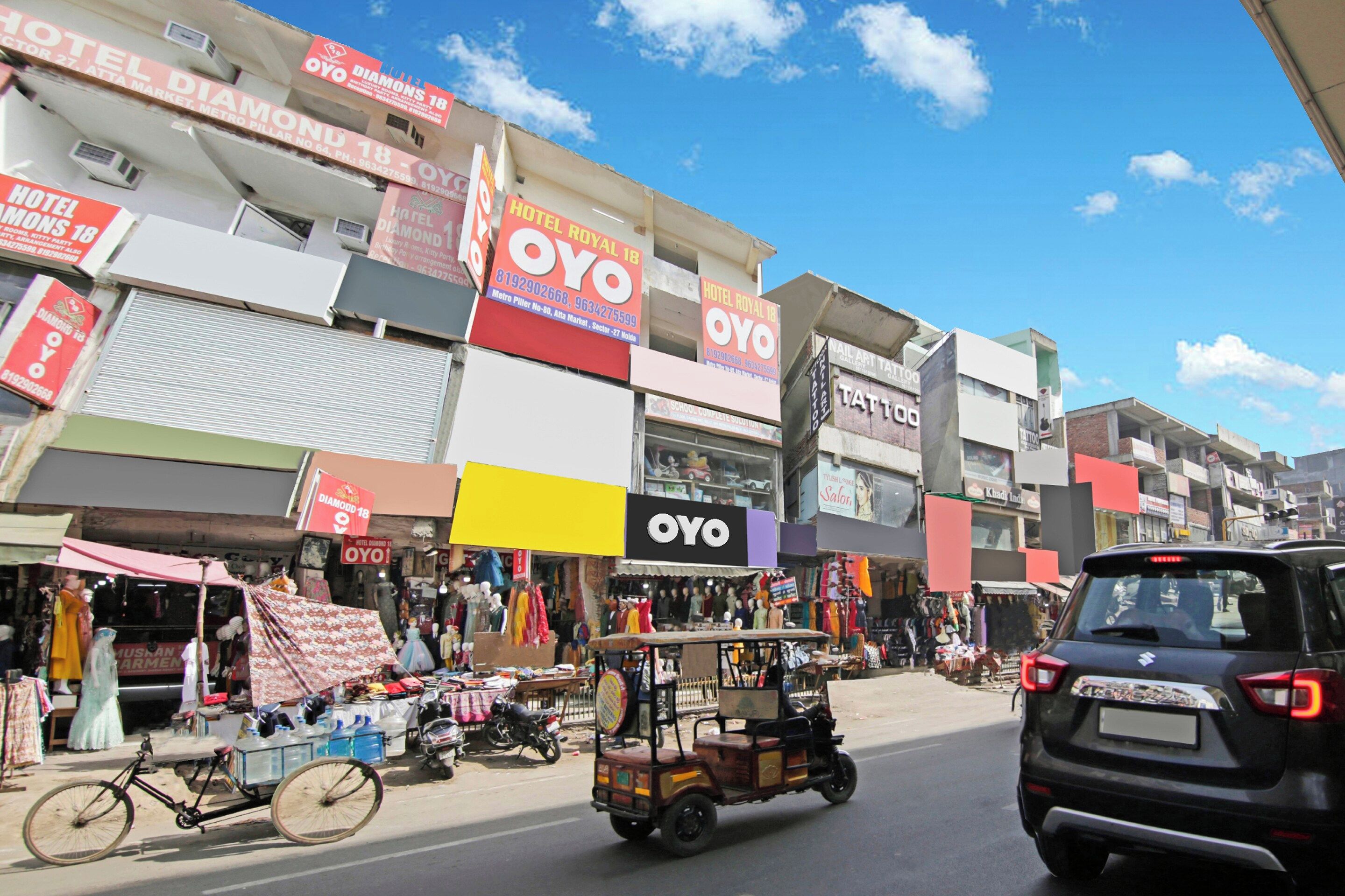 A street view with multiple storefronts, including a hotel and a nail salon.