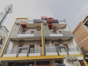 A multi-story building with a prominent sign reading 'Collection' and a red circular logo. - Collection O PRANJUL INN (Prayagraj)