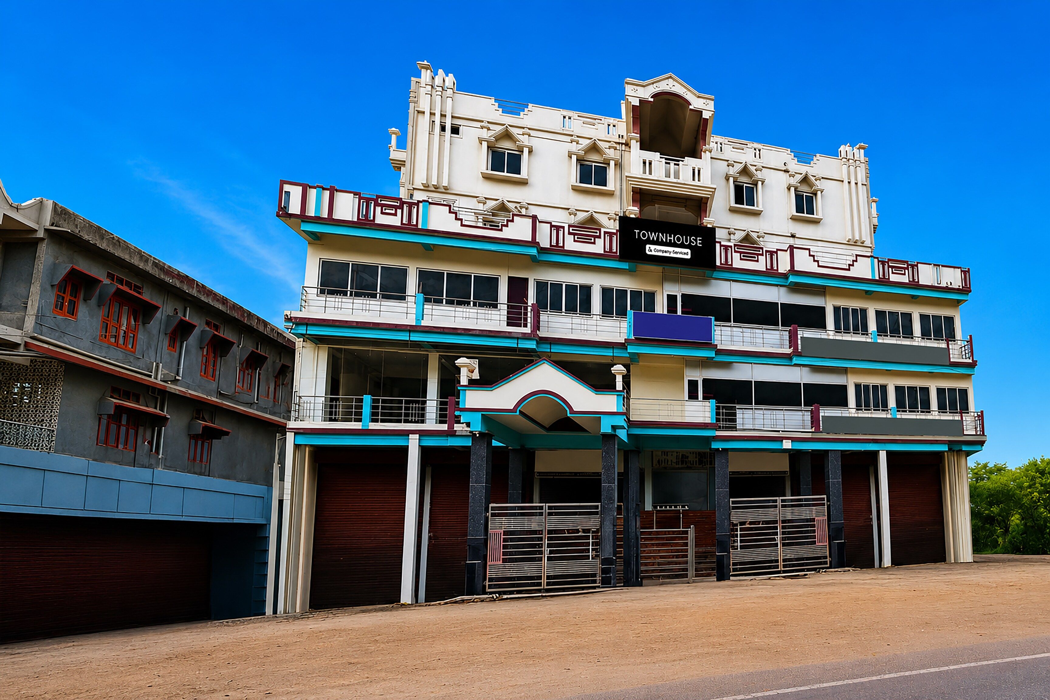A two-story building with a sign that reads 'TOWNHOUSE.'