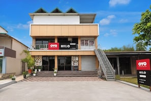 A two-story hotel with a modern design, featuring a prominent 'OYO HOTEL' sign.