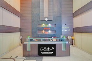 A reception desk with a sign that reads 'Collector° Company-Serviced.' - Super Collection O Dhanbad Railway (Dhanbad)