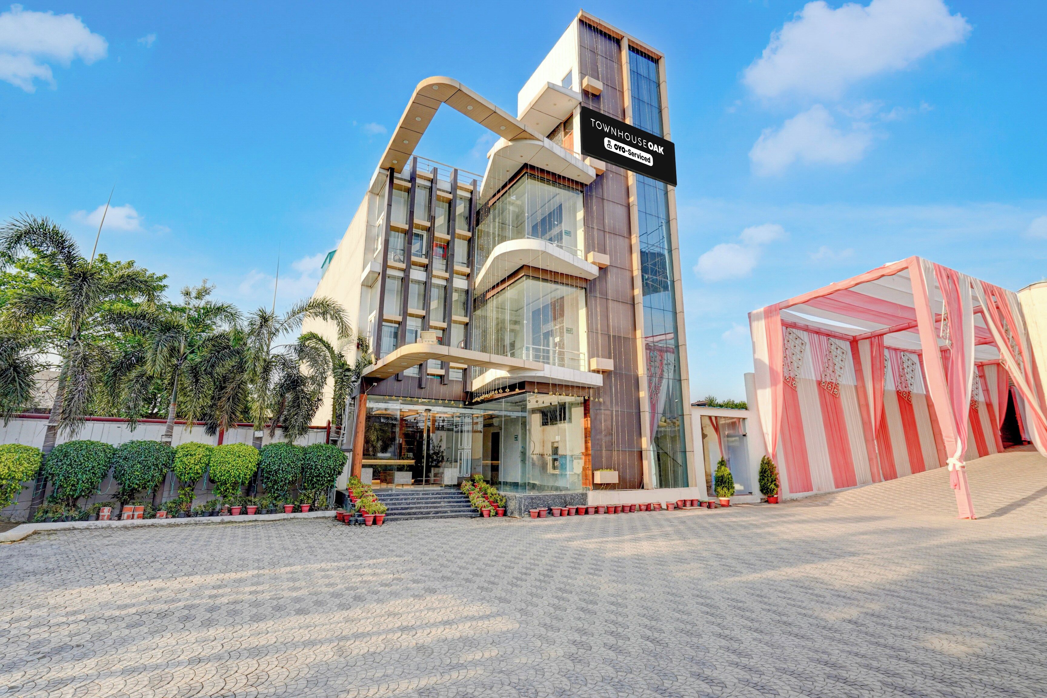 A modern building with a sign indicating it is serviced by OYO.