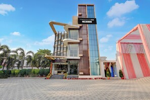 A modern building with a sign indicating it is serviced by OYO. - Townhouse Oak Phase 13 Varanasi (Varanasi)