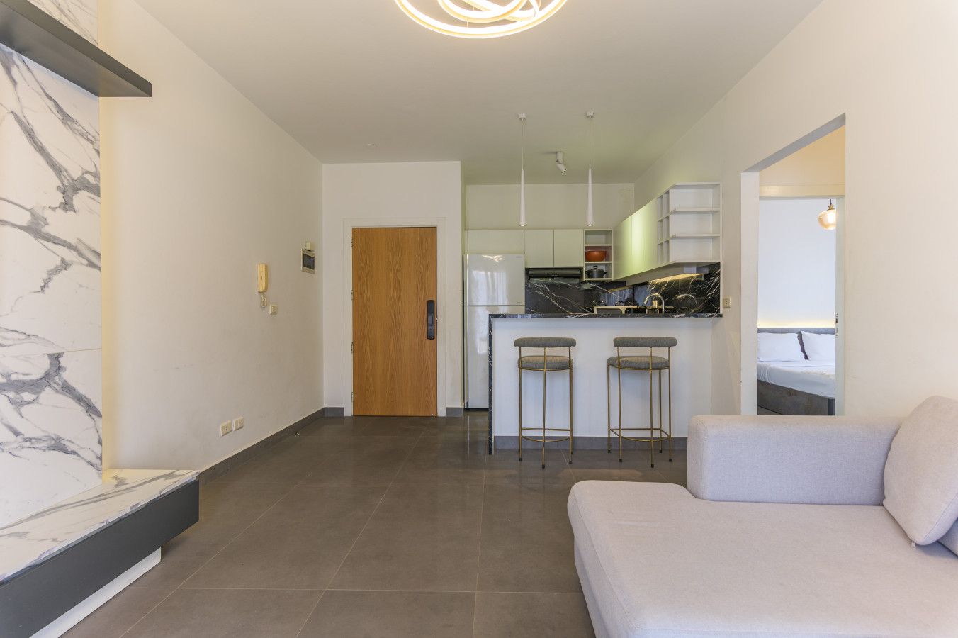 A modern interior with a kitchen, bar area, and a seating area.