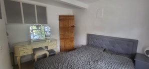 A bedroom with a bed, a desk, a chair, and a wardrobe. - Comfortable country retreat in a rural village. Pet and family friendly! (White Colne)