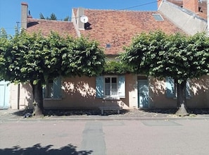 A building with a tiled roof, two trees in front, and a clear sky. - New Listing (Cosne-Cours-sur-Loire)