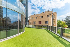 A modern building with a glass facade and a rooftop terrace with artificial grass. - Sodeco Ashrafieh by Stayinn (Beirut)