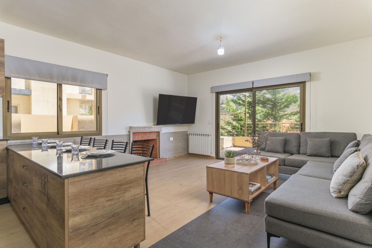 A modern living space with a kitchen, dining area, and a sofa.