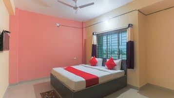 A bedroom with a bed, a ceiling fan, a window with curtains, and a view of the outside.