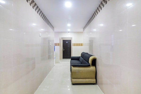 A hallway with a sofa and a door labeled '503' in a hotel or similar accommodation.