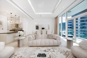 Un salon moderne comprenant un canapé, une table basse et un coin repas avec des chaises et une table.