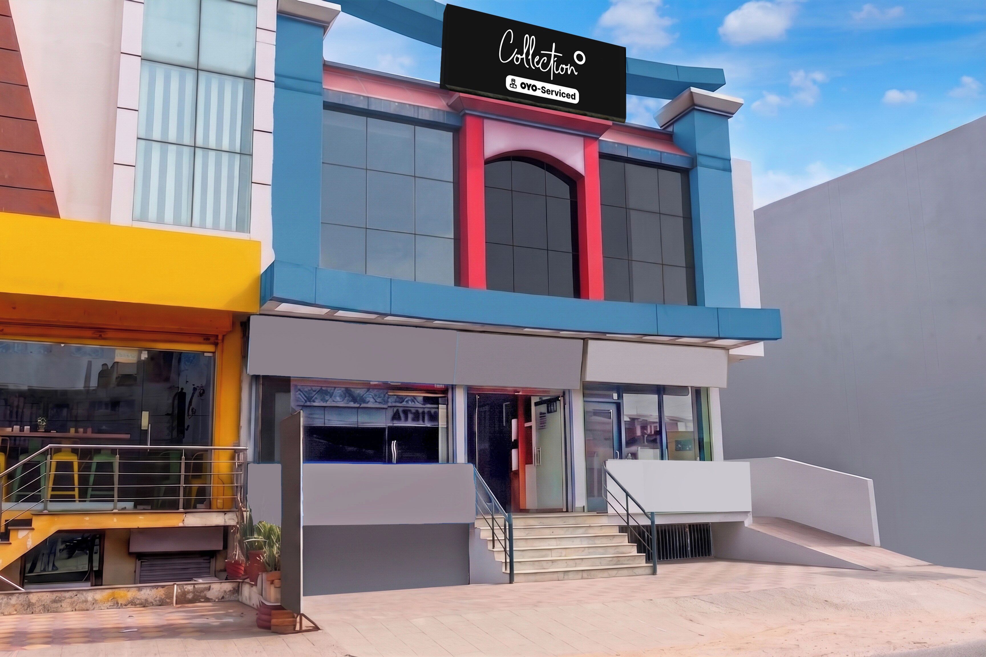 A modern building with a storefront labeled 'Collection Oyo-Serviced.'