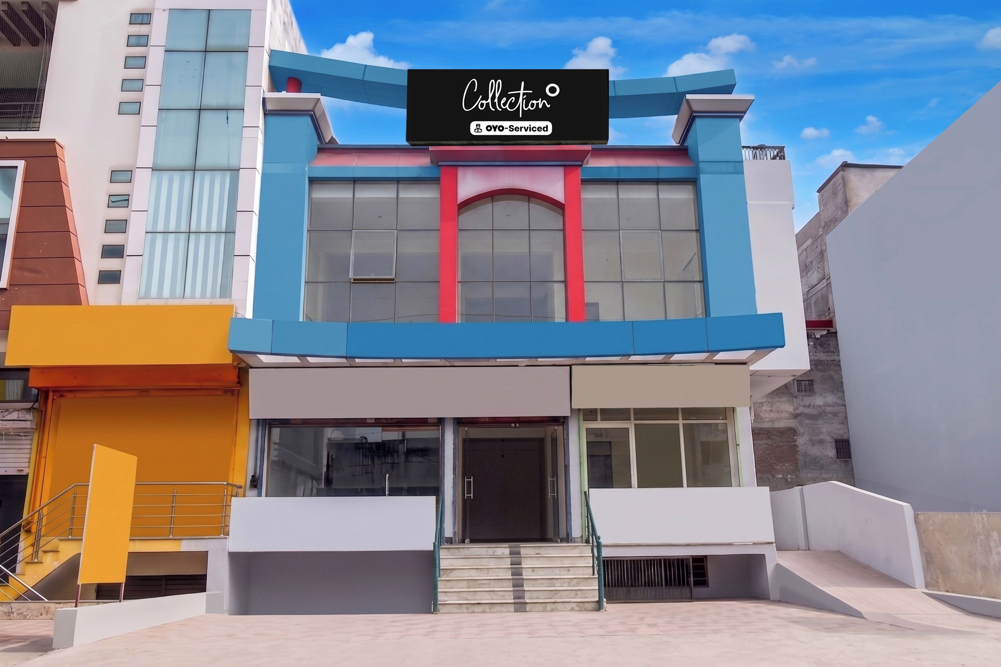 A modern building with a sign that reads 'Collection' and 'YO-Serviced'.
