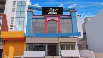 A modern building with a sign that reads 'Collection' and 'YO-Serviced'.