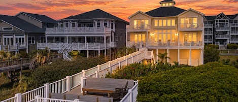 A coastal residential area with multiple houses featuring balconies and a wooden deck.