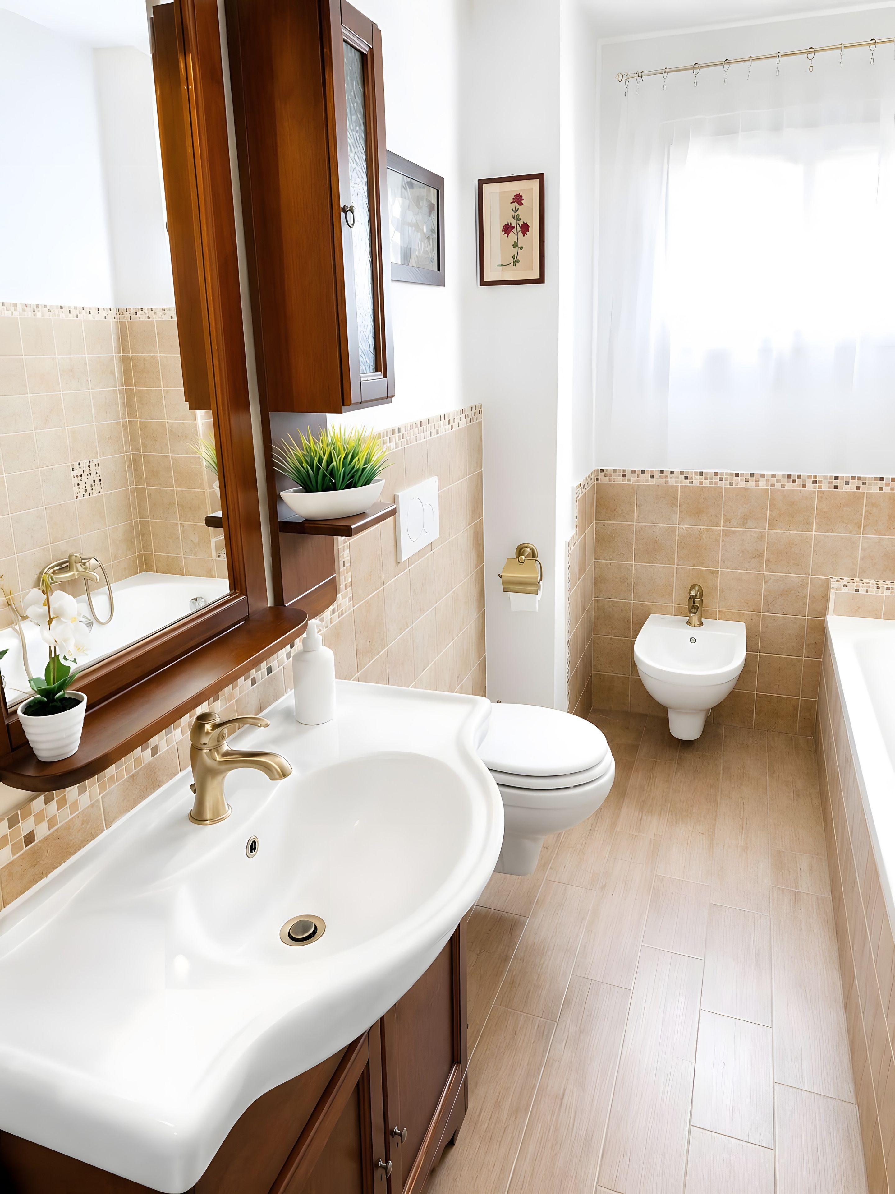 A bathroom with a sink, toilet, bidet, and bathtub.