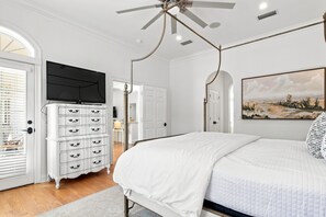 A bedroom with a bed, a dresser, a television, and a painting on the wall. - Welcome to Soleil House, a  Seacrest Beach retreat perfectly located on 30A. (Seacrest)