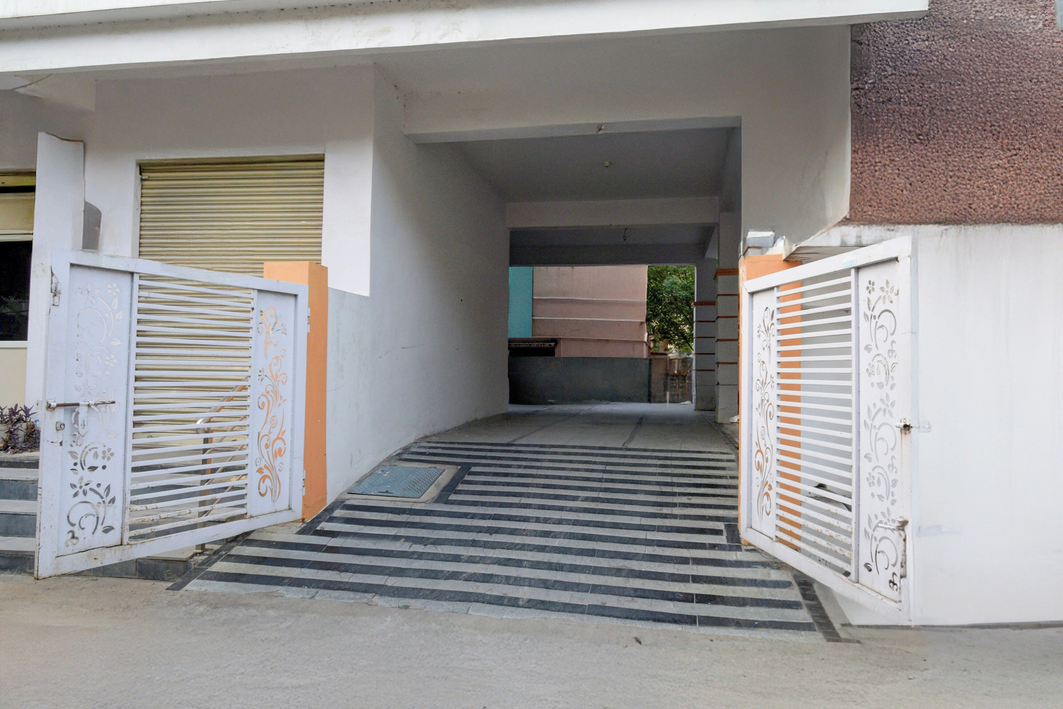 A gated entrance with a metal staircase leading to a covered area.