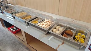 A buffet line with various food items in separate containers. - Wan yu apartment  (Guangzhou)