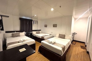A hotel room with three single beds, a small table, and a desk. - Emerald Bay Boracay (Boracay Island)