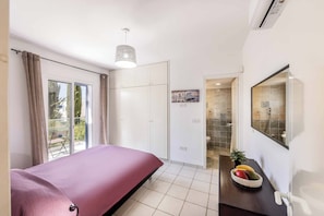 A bedroom with a bed, wardrobe, and a bathroom with a shower and toilet. - Villa Lilly Rose - Three Bedroom Villa, Sleeps 6 (Polis)