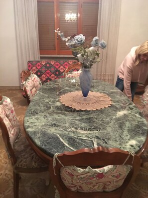 A dining table with a vase of flowers, a patterned tablecloth, and a lace doily. - countryside villa with pool quads next near beach mountains rome naples by train (Lazio)