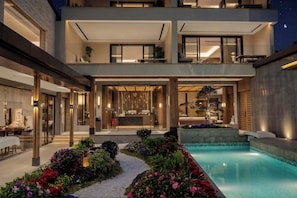 A modern two-story building with a swimming pool, outdoor seating, and a reception area. - Riverside Paradise Luxury Resort Villa (Guilin)