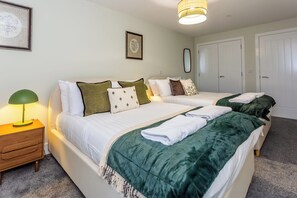 A hotel room with two beds, a nightstand with a lamp, and a wardrobe. - Toast Stays - The Bluebell at Parsons House (Washington)