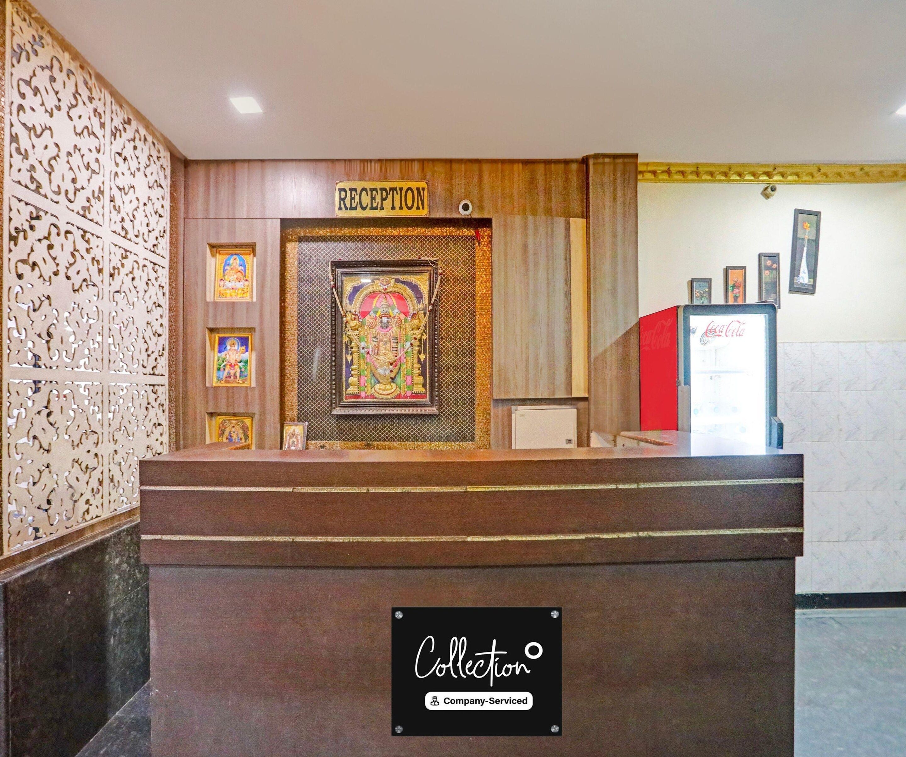 A reception desk with a 'RECEPTION' sign, framed religious artwork, and a 'Collection' sign indicating company service.