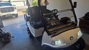 A golf cart with LED lights, a steering wheel, and a seat. - Cozy 2-bedroom house in the villages. (Wildwood)