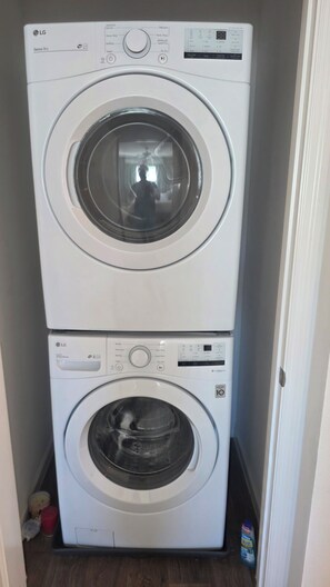 A stacked washer and dryer unit with a control panel and a digital display. - Cozy 2-bedroom house in the villages. (Wildwood)