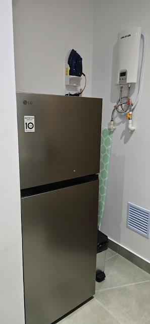 A stainless steel LG refrigerator with an inverter compressor, a water heater, and a vent. - New Studio Steps from Santa Marta Marina & Beach - A/C, Washer-Dryer (Santa Marta)