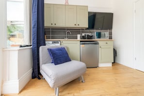 A compact kitchenette with a built-in microwave, a coffee maker, and a dishwasher. - Private Studio Near Shops & River Thames - Pass the Keys (Reading)