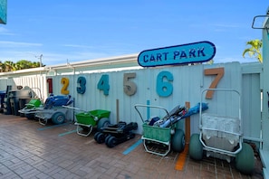 A cart parking area with numbered carts and a sign indicating 'Cart Park'. - Old-Fl Retreat, Walk to Beach & Village, Heated Pool (Siesta Key)