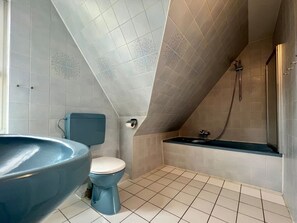 A bathroom with a toilet, sink, and shower. - Holiday Home in Nieblum With Swimming Pool (Nieblum)