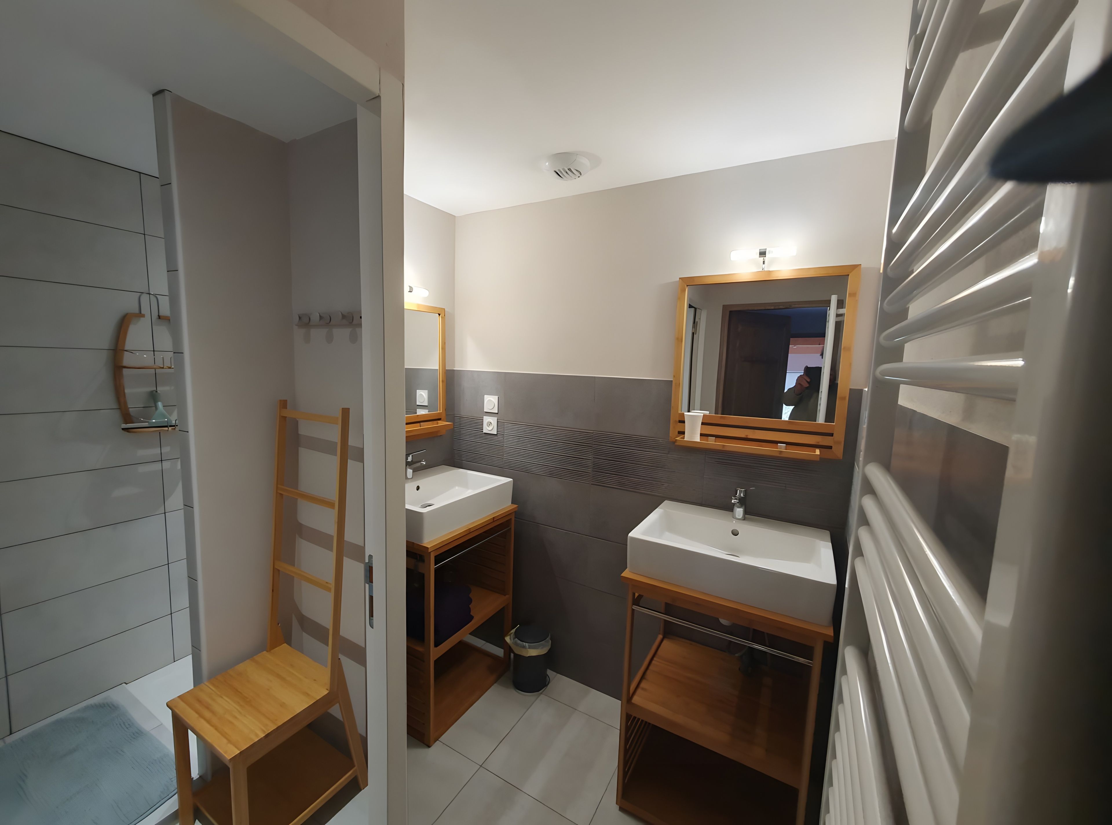 A bathroom with a shower, a sink, and a mirror.