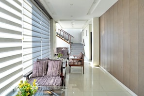 A modern interior with a dining area, a staircase, and a textured wall.