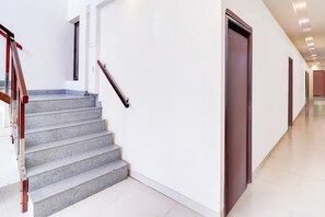 A modern interior with a staircase, a door, and a hallway. - Super Collection O Prem Nagar Dehradun (Dehradun)