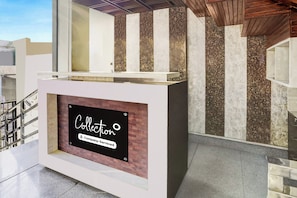 A reception desk with a sign that reads 'Collection Company-Serviced'. - Super Collection O Prem Nagar Dehradun (Dehradun)