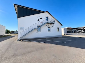 A building with a white facade, a black roof, and a staircase leading to a balcony. - Apartment 'Nr. 4' with Wi-Fi (Jettingen-Scheppach)