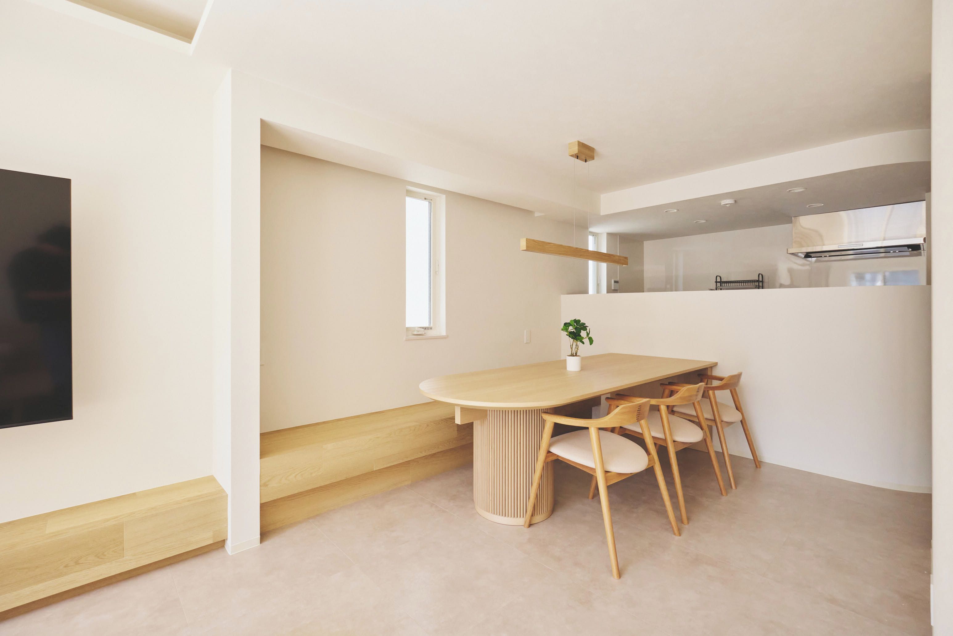 A modern kitchen with a built-in oven and a window above the counter.