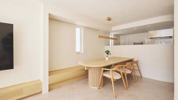 A modern kitchen with a built-in oven and a window above the counter.